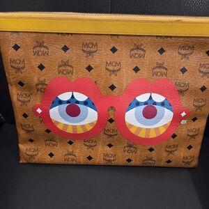 MCM Tan Clutch with Red and Blue Graphic